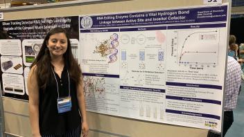 Student presenter standing beside a research poster on RNA editing enzymes.